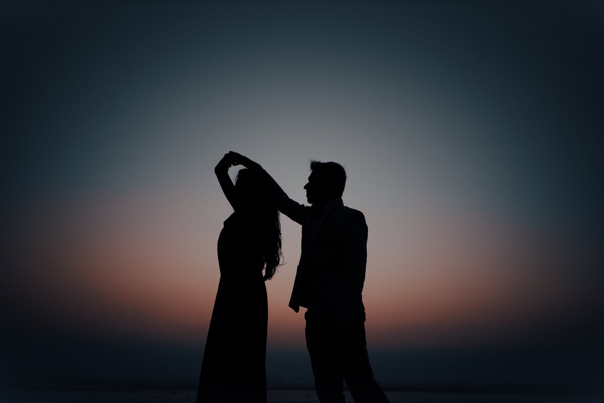 Silhouette of a couple dancing at sunset - representing the essence of love and spiritual connection
